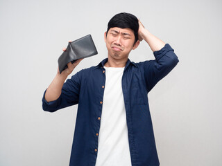 Asian man feels headache about no money in his wallet