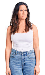 Young beautiful brunette woman wearing casual sleeveless t-shirt skeptic and nervous, frowning upset because of problem. negative person.