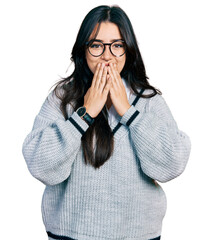 Beautiful hispanic woman wearing casual sweater and glasses laughing and embarrassed giggle...