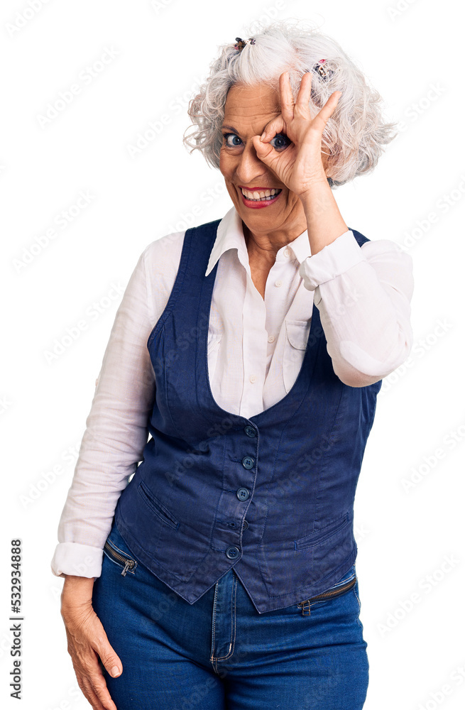 Wall mural Senior grey-haired woman wearing casual clothes smiling happy doing ok sign with hand on eye looking through fingers