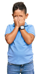 Little boy hispanic kid wearing casual clothes rubbing eyes for fatigue and headache, sleepy and...