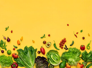 Photo of organic different lettuces and vegetables on yellow background. Top view. High resolution product