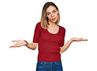 Young blonde girl wearing casual clothes clueless and confused with open arms, no idea concept.