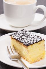 Cup of coffee with milk and fresh baked cheesecake. Delicious dessert