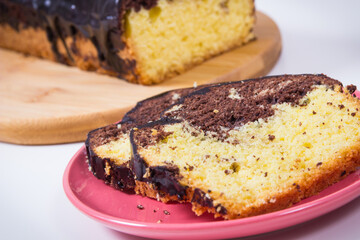 Fresh baked yeast dough with cocoa and chocolate icing. Delicious dessert. White background