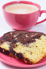 Fresh baked yeast dough with cocoa and chocolate icing, cup of coffee with milk. Delicious dessert