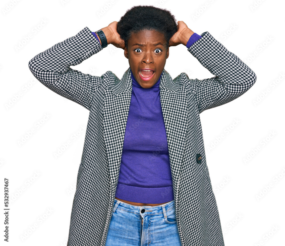 Sticker Young african american girl wearing casual clothes crazy and scared with hands on head, afraid and surprised of shock with open mouth