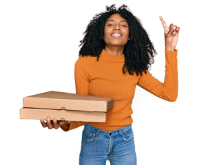 Young african american girl holding delivery pizza box surprised with an idea or question pointing finger with happy face, number one