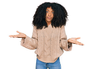 Young african american girl wearing casual clothes clueless and confused expression with arms and hands raised. doubt concept.