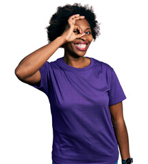 Fototapeta na wymiar African american woman with afro hair wearing casual purple t shirt doing ok gesture with hand smiling, eye looking through fingers with happy face.