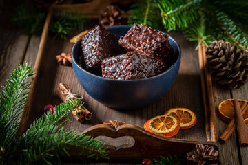 Gingerbread cubes with chocolate glaze on wooden tray for Christmas