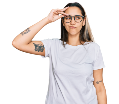 Young hispanic woman wearing casual white t shirt worried and stressed about a problem with hand on forehead, nervous and anxious for crisis