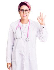 Young beautiful woman with pink hair wearing doctor uniform smiling positive doing ok sign with hand and fingers. successful expression.