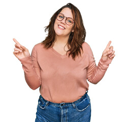 Young plus size woman wearing casual clothes and glasses smiling confident pointing with fingers to different directions. copy space for advertisement