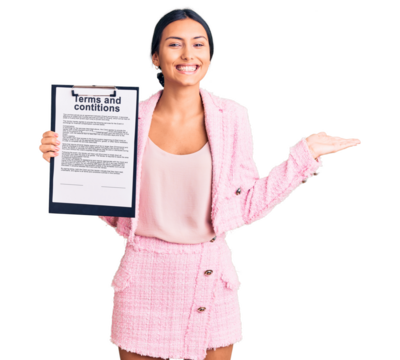 Young beautiful latin girl holding clipboard with terms and conditions document celebrating victory with happy smile and winner expression with raised hands