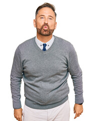 Fototapeta premium Handsome middle age man wearing business clothes looking at the camera blowing a kiss on air being lovely and sexy. love expression.