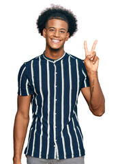 African american man with afro hair wearing casual clothes showing and pointing up with fingers number two while smiling confident and happy.