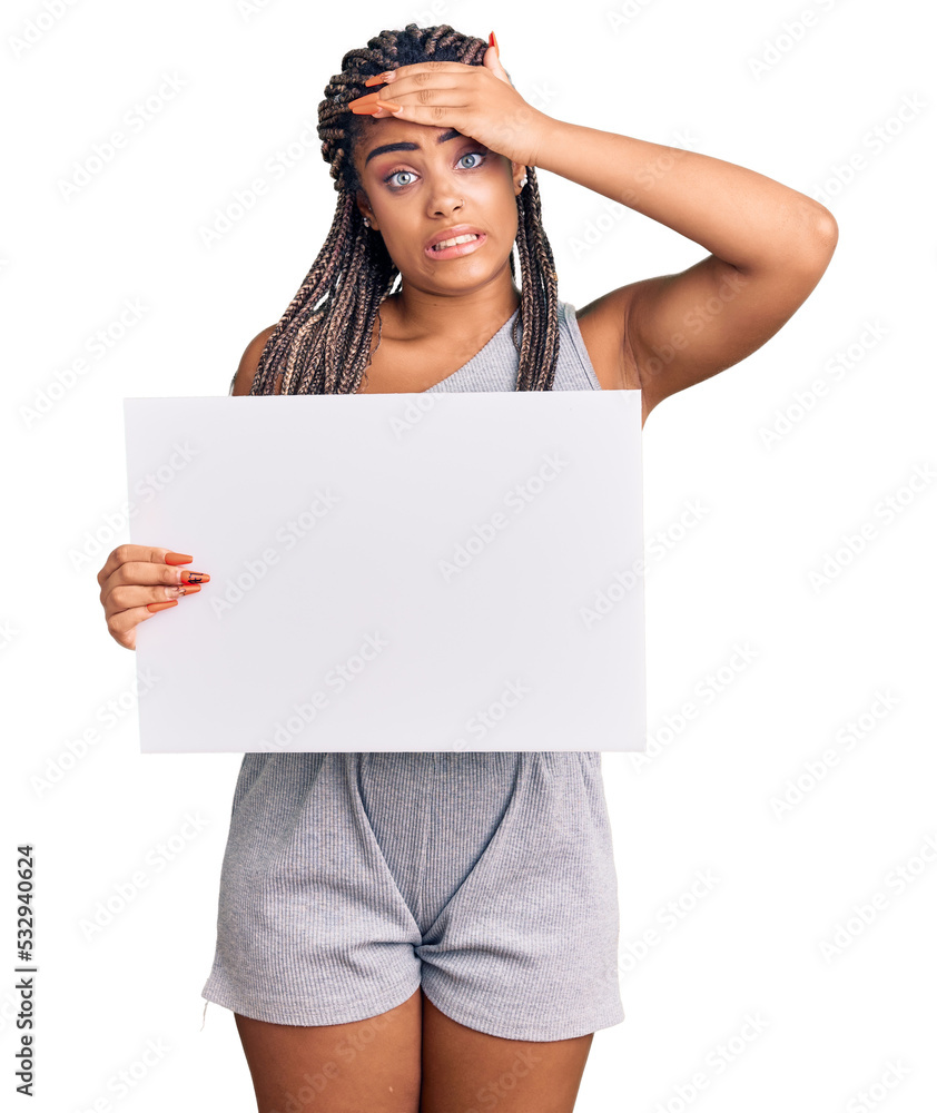 Sticker Young african american woman with braids holding blank empty banner stressed and frustrated with hand on head, surprised and angry face