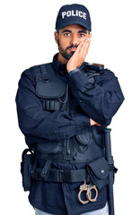 Young hispanic man wearing police uniform thinking looking tired and bored with depression problems with crossed arms.