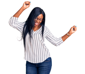 Young african american woman wearing casual clothes and glasses dancing happy and cheerful, smiling moving casual and confident listening to music