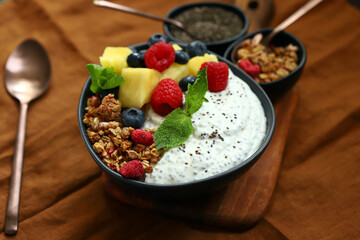 Healthy breakfast bowl with chia yogurt, crunches and fruits.