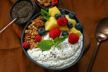 Healthy breakfast bowl with chia yogurt, crunches and fruits.