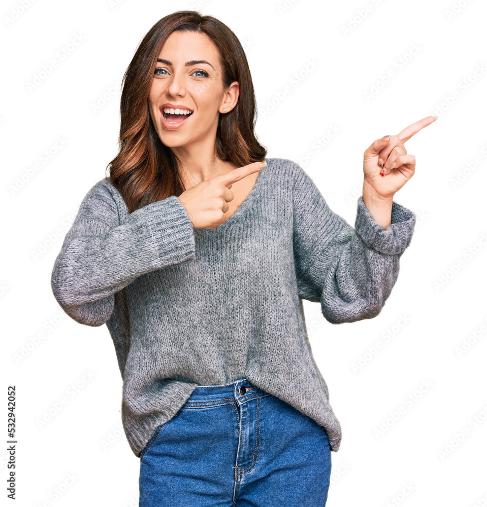 Sticker young brunette woman wearing casual winter sweater smiling and looking at the camera pointing with t