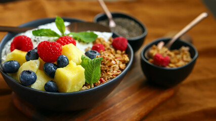 Healthy breakfast bowl with chia yogurt, crunches and fruits.