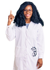 Beautiful african american optician woman with optometry glasses pointing finger up with successful idea. exited and happy. number one. - obrazy, fototapety, plakaty