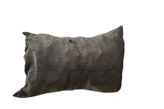 Old and dirty sack that contains coals inside, isolated on white background. Concept : natural  materials that use to be container and can decompose naturally for environment.       