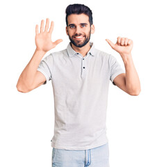 Young handsome man with beard wearing casual polo showing and pointing up with fingers number six while smiling confident and happy.