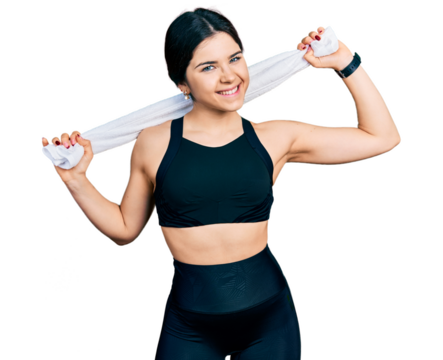 Young brunette woman with blue eyes wearing sportswear and towel smiling with a happy and cool smile on face. showing teeth.
