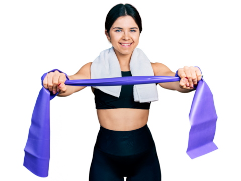 Young brunette woman with blue eyes training arm resistance with elastic arm bands smiling with a happy and cool smile on face. showing teeth.