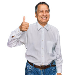 Middle age indian man wearing casual white shirt smiling happy and positive, thumb up doing...