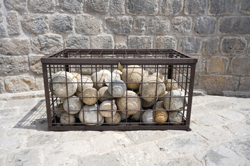  Pile of ancient medieval round stone cannonballs   