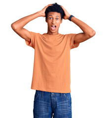 Young african american man wearing casual clothes crazy and scared with hands on head, afraid and surprised of shock with open mouth