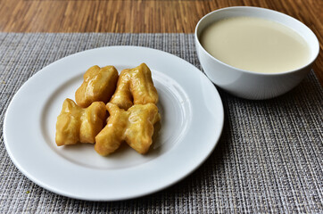 Deep fried dough stick with condensed milk and soy milk good breakfast of the day before start your work.