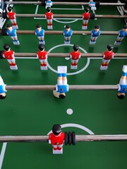 Arcade table soccer with tools for playing for office and home games.