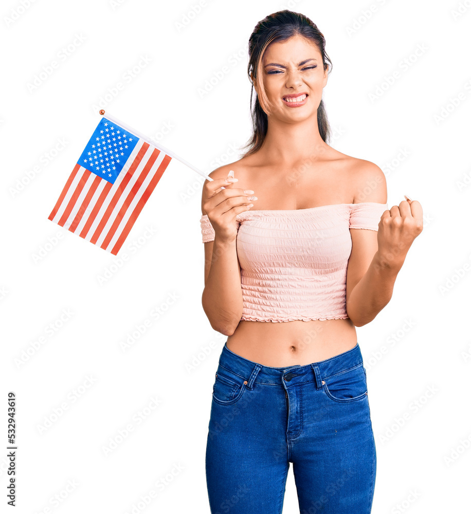 Poster young beautiful woman holding united states flag annoyed and frustrated shouting with anger, yelling