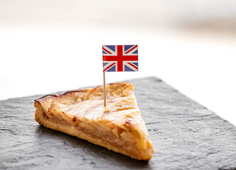 United Kingdom, dessert and bakery, slice of apple tart with British flag, close-up - Powered by Adobe