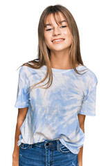 Obraz premium Teenager caucasian girl wearing casual clothes looking positive and happy standing and smiling with a confident smile showing teeth
