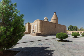 Fototapeta premium Ancient heritage Chashma-Ayub Mausoleum with conical dome surrounded by trees, Bukhara, Uzbekistan