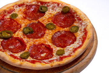 Closeup of pizza with pepperoni and jalapeno pepper