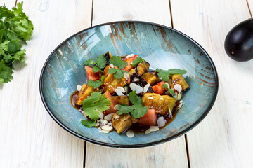 salad with fried eggplant, tomatoes and nuts