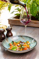 salad with fried eggplant and tomatoes, served with red wine