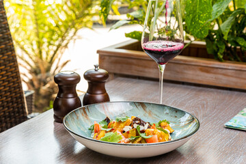salad with fried eggplant and tomatoes, served with red wine