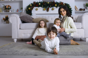 Fototapeta premium A young family with children decorates the house for the holiday. New Years Eve. Waiting for the new year.