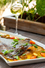 sea delicacy, sea food, fried flounder with vegetables, served with white wine