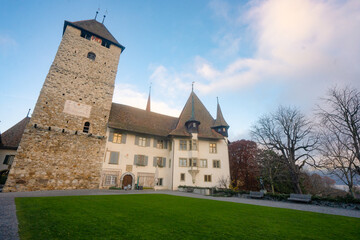 Fototapeta na wymiar Spiez Castle , Museum , Tower . Medieval castle on the hills near Lake Thun during autumn , winter morning : Spiez , Switzerland : December 4 , 2019