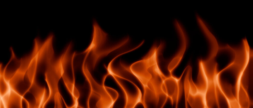Bright flames of fire on a black background, realistic abstract flames.